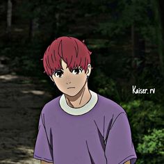 a young man with red hair standing in the woods