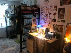 a bedroom with a bunk bed, desk and laptop computer on top of the desk