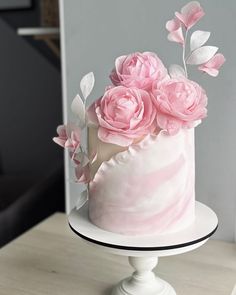 a white cake with pink flowers on top