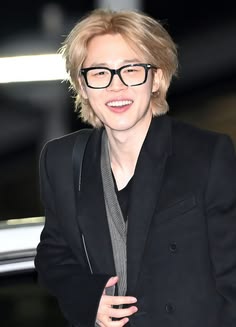 a person wearing glasses and a black jacket