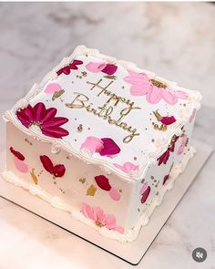a birthday cake with pink flowers on it