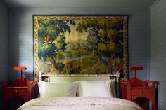 a bedroom with a tapestry hanging above the bed