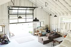 an overhead view of a living room and kitchen area in a loft style building with high ceilings