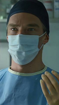 a man in scrubs wearing a surgical mask
