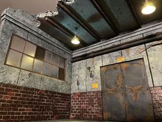 an empty room with brick walls and two doors that have been boarded up to the ceiling