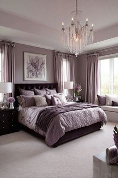 a bedroom with a large bed and chandelier