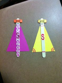 two pieces of paper cut out to look like children's clothes with numbers on them