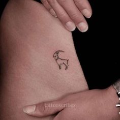 a small goat tattoo on the right side of the thigh, which is black and white