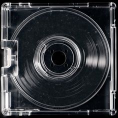 a clear plastic case with an empty cd inside the lid on a black background photo
