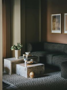 a living room with a couch, coffee table and pictures on the wall