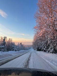 a car driving down a snow covered road