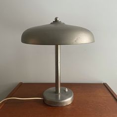 a lamp sitting on top of a wooden table