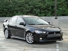 a black car parked in a parking lot