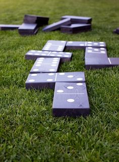 dominos laid out in the grass on top of each other