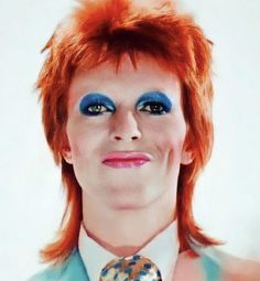 a man with red hair and blue eyes wearing a tie