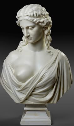 a white marble bust of a woman with braids
