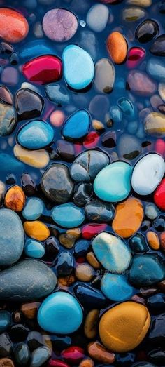 many different colored rocks in the water