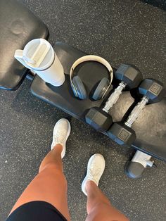 a person standing next to a skateboard with headphones on it's wheels