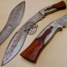 three knives with wood handles are sitting on a table next to a stamp that says hand made