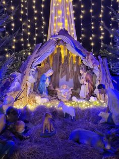 a nativity scene with the birth of jesus and baby jesus surrounded by christmas lights