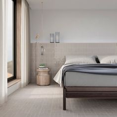 a bed sitting in a bedroom next to a window