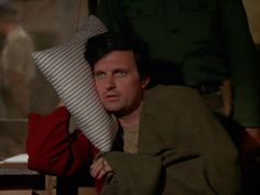 the man is laying down with his head on a pillow