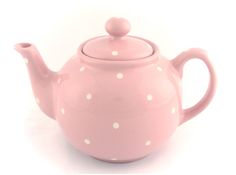 a pink teapot with white polka dots on it