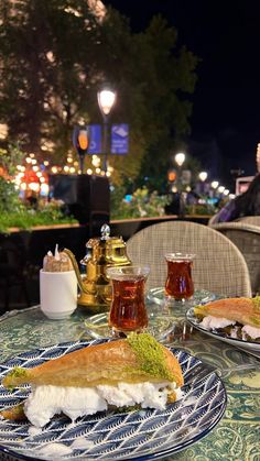 two plates with sandwiches on them sitting on a table
