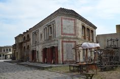 an old building sitting on the side of a road