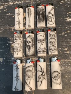 eight lighters with skulls and bones on them