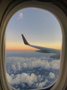 an airplane window looking out at the clouds