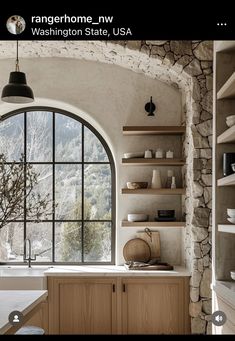 a kitchen with an arched window, sink and countertop is shown in this image