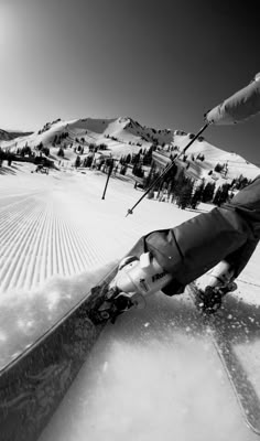 a person riding skis down a snow covered slope