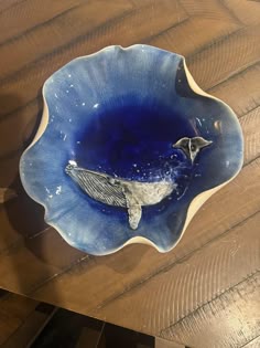 a blue bowl with a whale on it