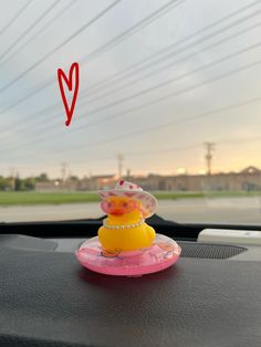 a rubber duck sitting on top of a car dashboard