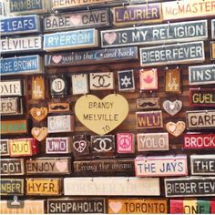 many different types of signs are stacked on top of each other in the shape of a heart