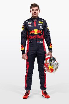 a man in a red bull racing suit holding a helmet