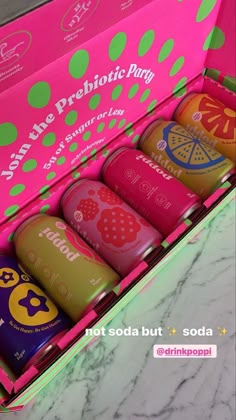 an open pink box with six different flavored teas in it