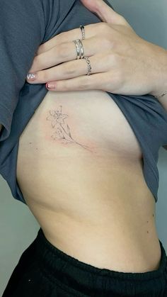 a pregnant woman's belly with tattoos on it