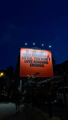 an advertisement on the side of a building in front of a dark sky at night
