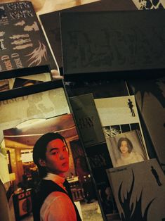 several books are stacked on top of each other with the covers pulled back to reveal an image