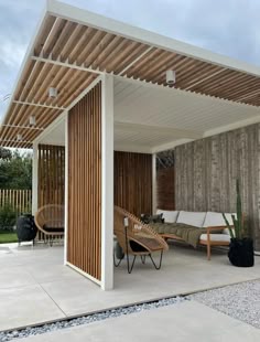 an outdoor living area with wooden slatted walls