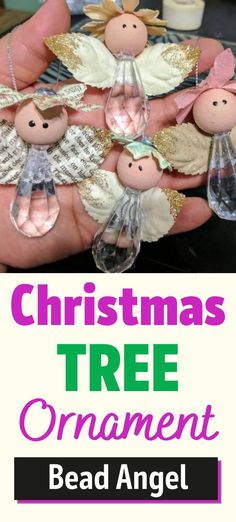 christmas tree ornament with angel figurines in the palm of someone's hand