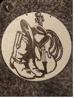 a wooden ornament with an image of a woman holding a guitar on it