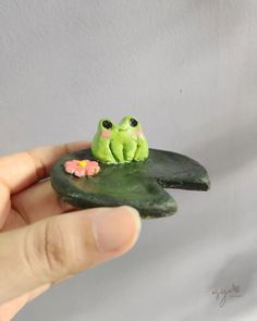 there is a small frog sitting on top of a leaf