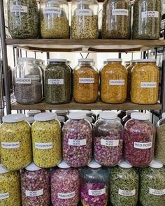 many jars filled with different types of food on shelves in a grocery store, all labeled with labels