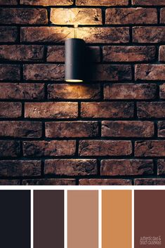 a brick wall with a light on it and some colors to choose from in the background