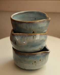 three ceramic bowls stacked on top of each other