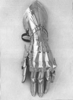 an old photo of a hand that has been made into a glove with spikes on it