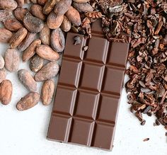 chocolate and nuts are on the table next to each other